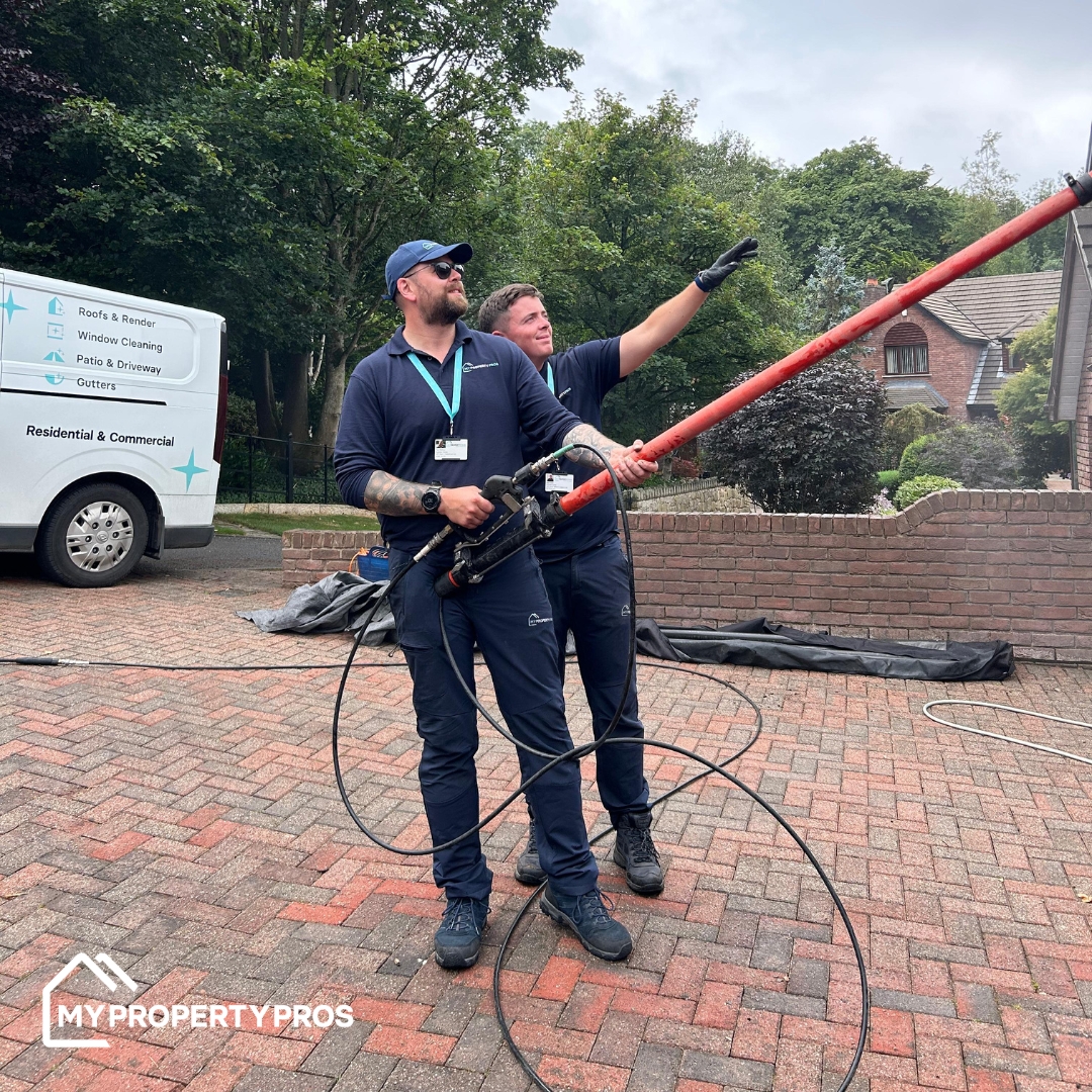Aidan Davis training another franchisee on a roof-cleaning job